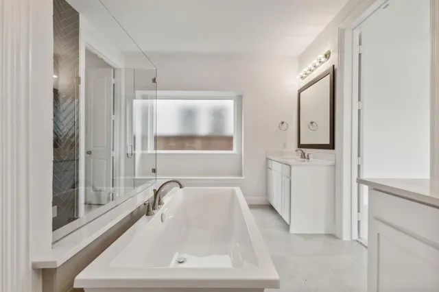 a bathroom with a sink mirror and window