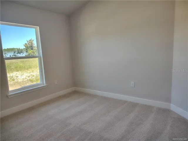 a bathroom with a granite countertop toilet sink and mirror