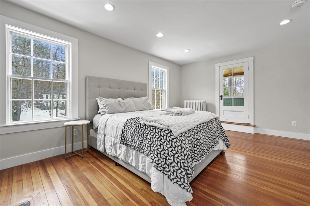 40 Haskell Street Beverly, MA 01915 - Photo 13 of 38 a bedroom with a bed and wooden floor