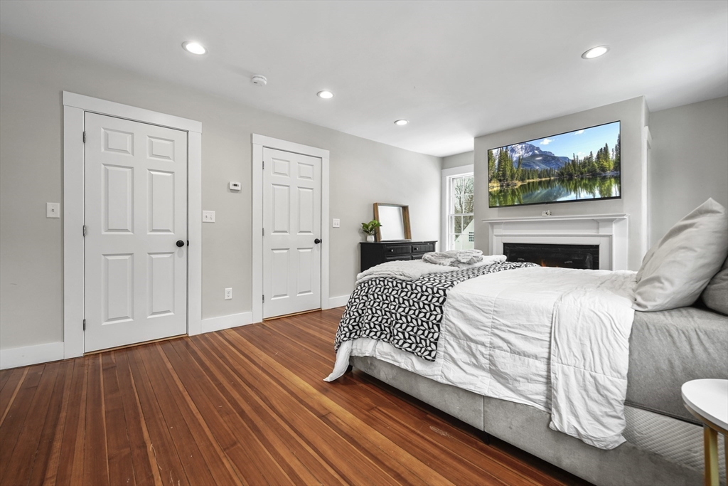 40 Haskell Street Beverly, MA 01915 - Photo 14 of 38 a bedroom with a bed and a flat screen tv