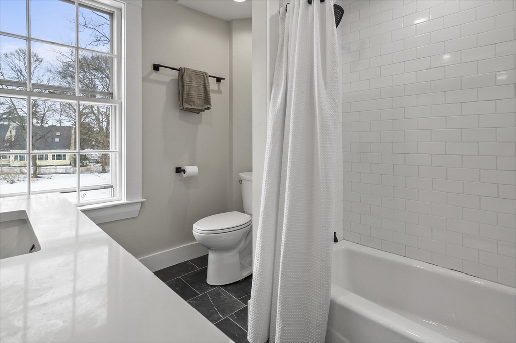 40 Haskell Street Beverly, MA 01915 - Photo 18 of 38 a bathroom with a toilet and a shower