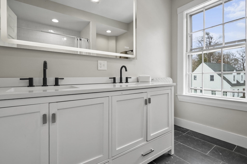 40 Haskell Street Beverly, MA 01915 - Photo 19 of 38 a kitchen with white cabinets and a sink