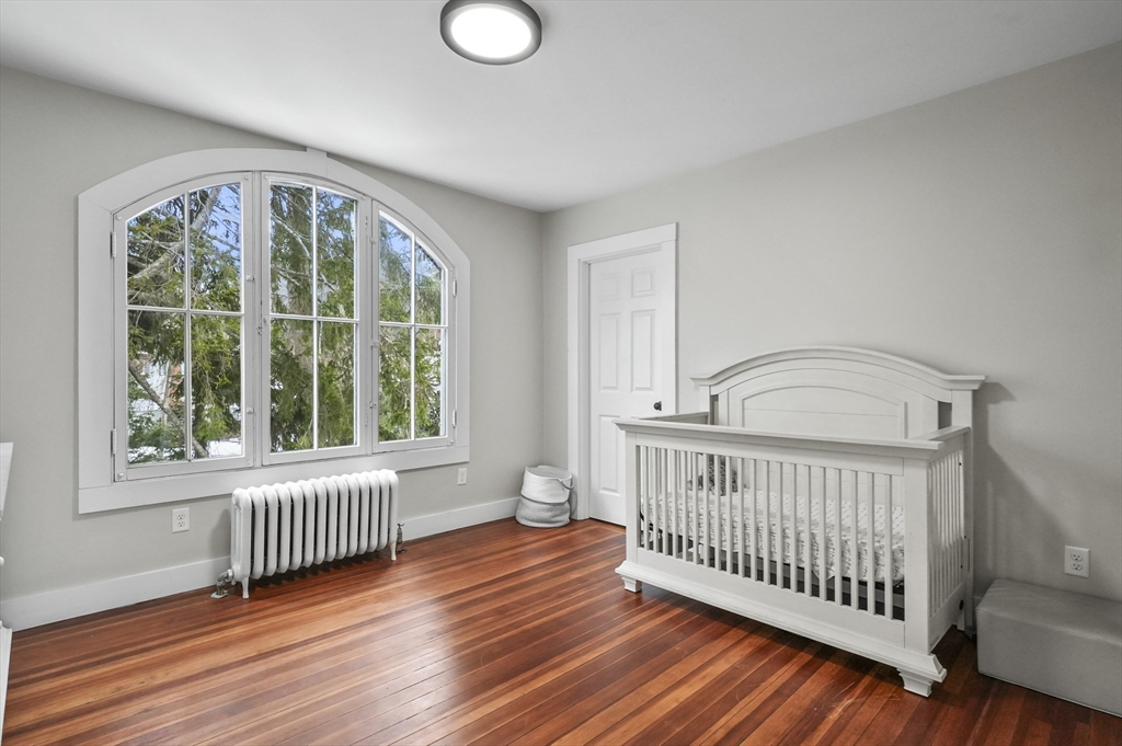 40 Haskell Street Beverly, MA 01915 - Photo 20 of 38 a view of an empty room with a window and wooden floor