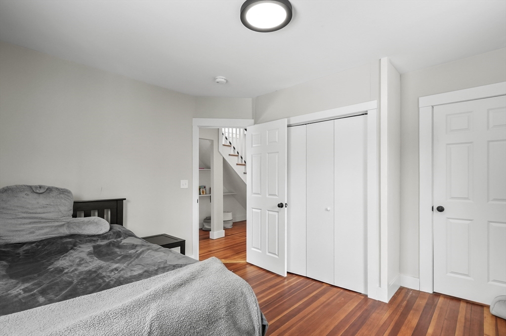 40 Haskell Street Beverly, MA 01915 - Photo 23 of 38 a bedroom with a bed and a chandelier