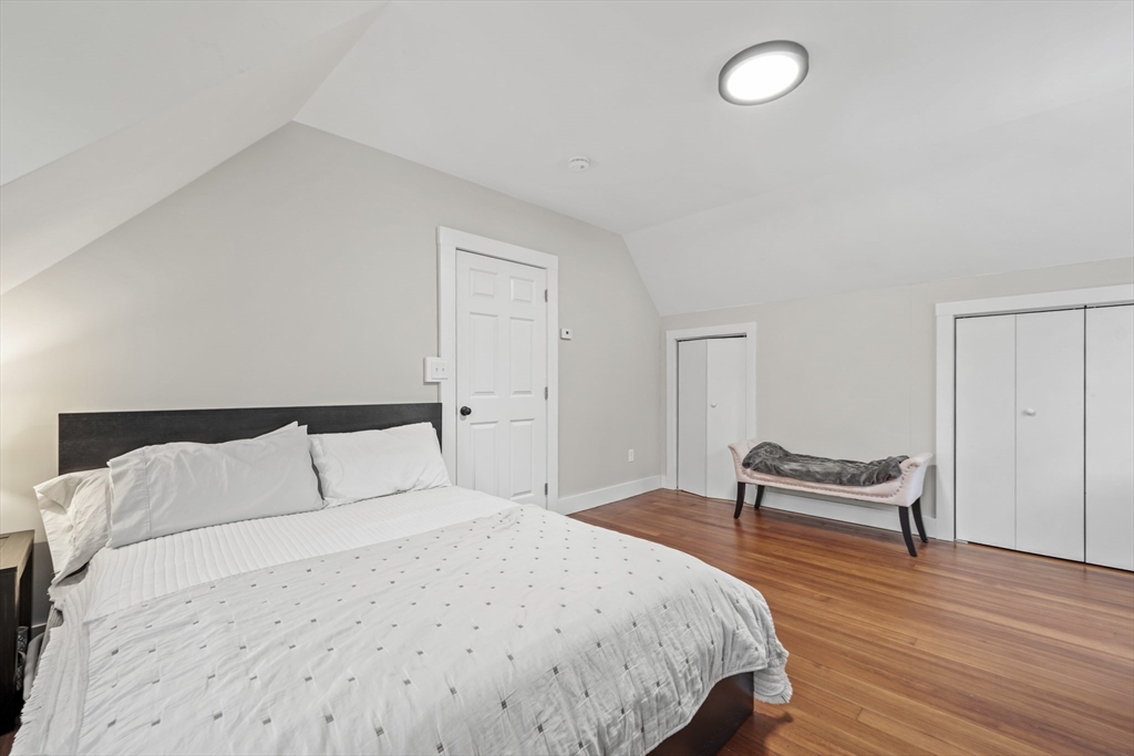 40 Haskell Street Beverly, MA 01915 - Photo 31 of 38 a bedroom with a bed and a chair