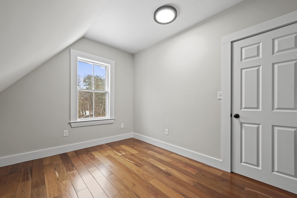 40 Haskell Street Beverly, MA 01915 - Photo 32 of 38 an empty room with wooden floor and windows