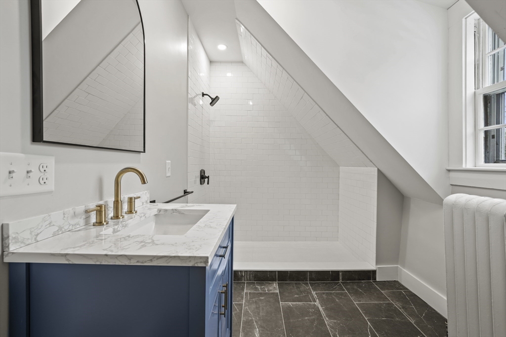 40 Haskell Street Beverly, MA 01915 - Photo 33 of 38 a bathroom with a sink and a mirror