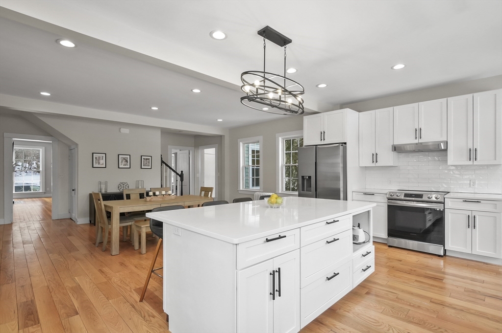 40 Haskell Street Beverly, MA 01915 - Photo 9 of 38 a large kitchen with stainless steel appliances lots of counter space and wooden floor
