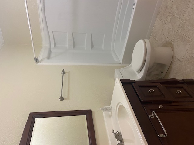 1034 Magnolia Street Lockhart, TX 78644 - Photo 10 of 12 Bathroom with vanity, bathtub / shower combination, and light tile patterned flooring