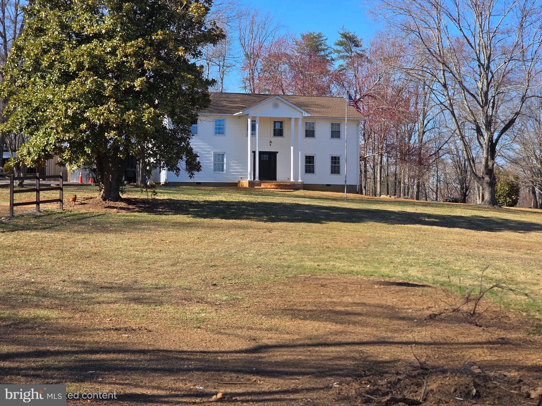 a front view of residential houses with yard and trees