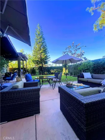 a view of a patio with a dining table and chairs under an umbrella
