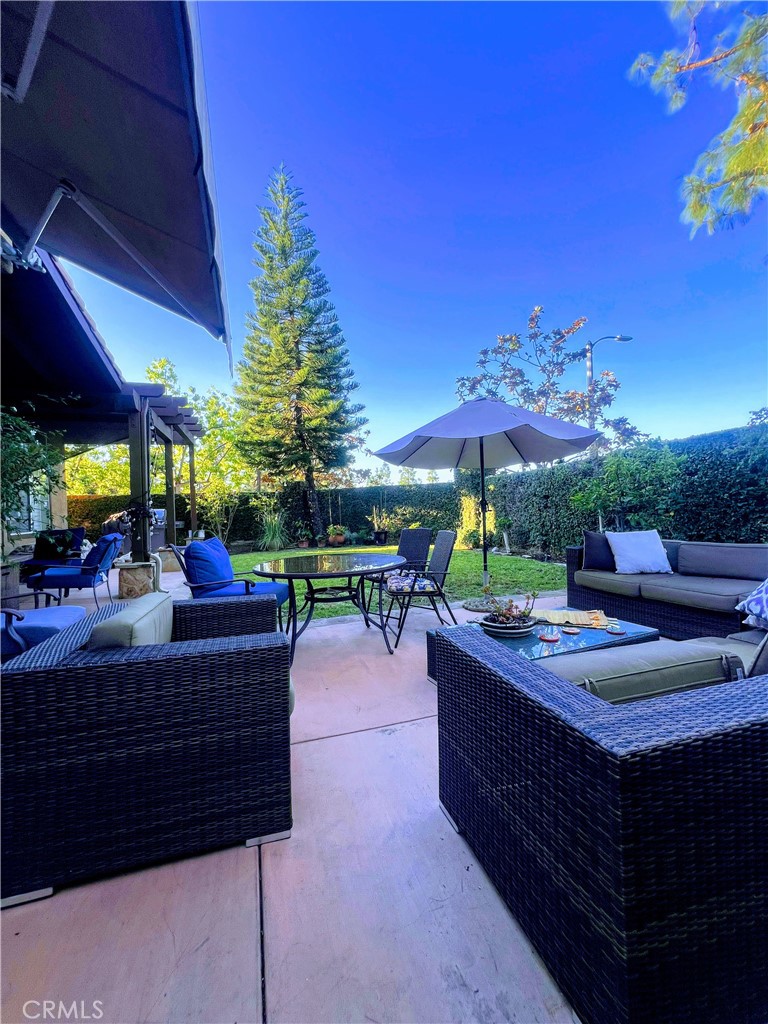 11105 Means Tustin, CA 92782 - Photo 11 of 23 a view of a patio with a dining table and chairs under an umbrella