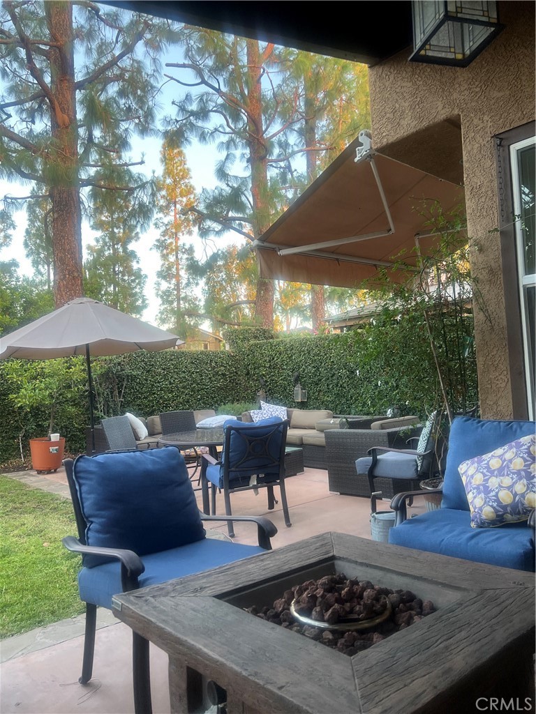 11105 Means Tustin, CA 92782 - Photo 12 of 23 a view of a patio with couches table and chairs under an umbrella