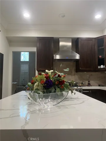a view of a lobby with a couch and a potted plant