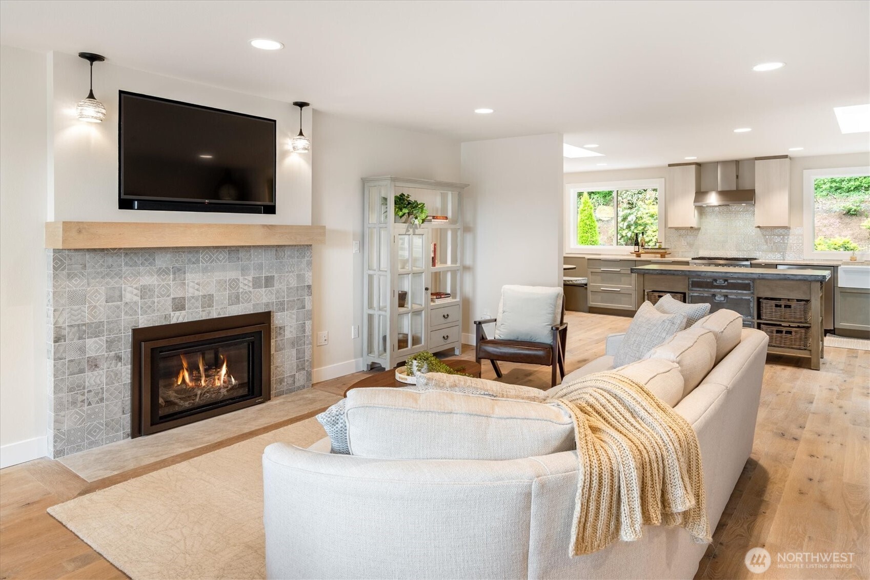 9503 Odin Way Bothell, WA 98011 - Photo 7 of 39 a living room with furniture a fireplace and a flat screen tv