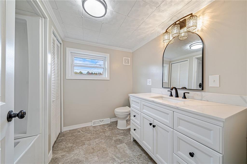 1109 Baggaley Avenue Latrobe, PA 15650 - Photo 16 of 36 a spacious bathroom with a double vanity sink mirror and toilet