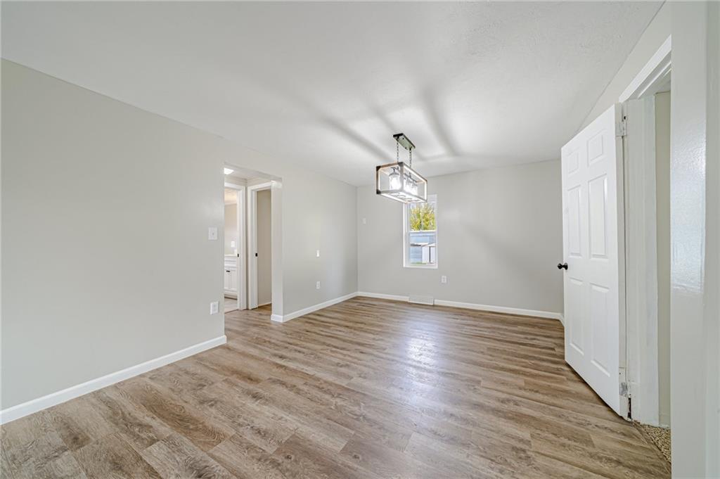 1109 Baggaley Avenue Latrobe, PA 15650 - Photo 6 of 36 wooden floor in an empty room with a window