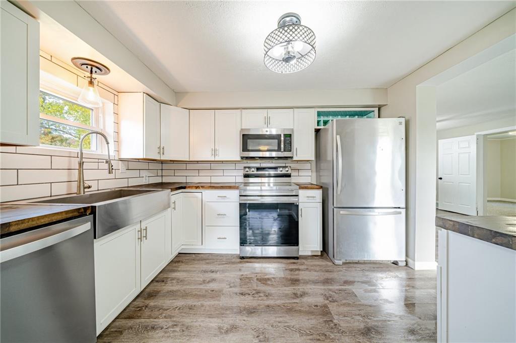 1109 Baggaley Avenue Latrobe, PA 15650 - Photo 9 of 36 a kitchen with a refrigerator and a stove top oven