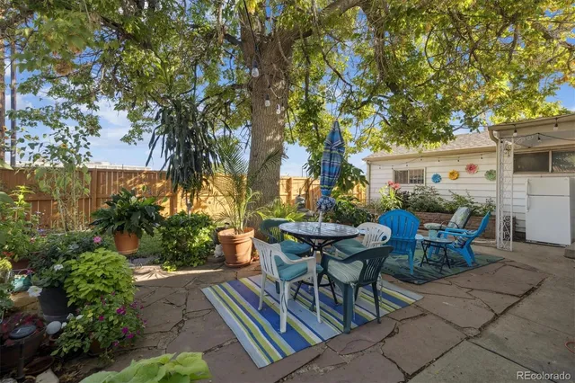 a view of a house with backyard sitting area and garden