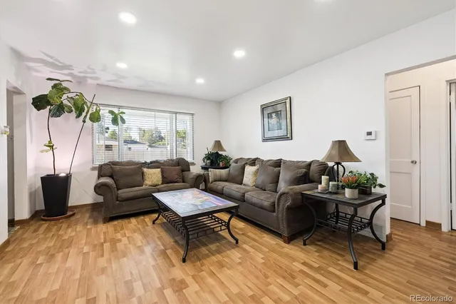 a living room with furniture and wooden floor