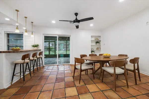 a dining room with a table and chairs