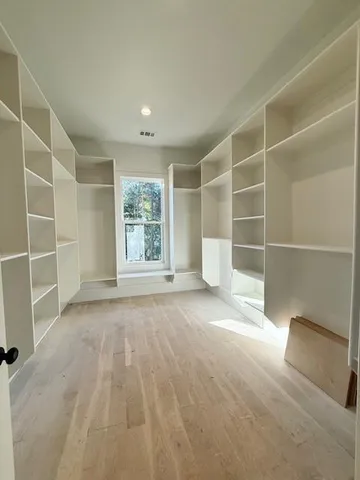 a kitchen with stainless steel appliances granite countertop a sink a stove and a wooden floors