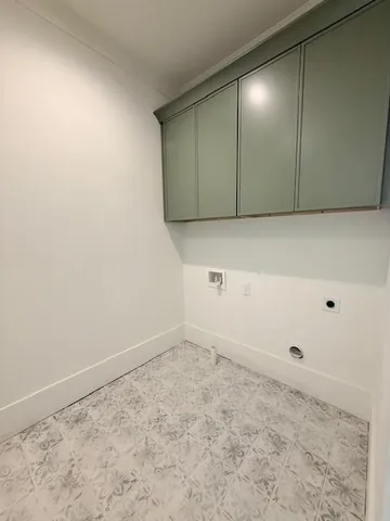 a view of empty room with wooden floor and window
