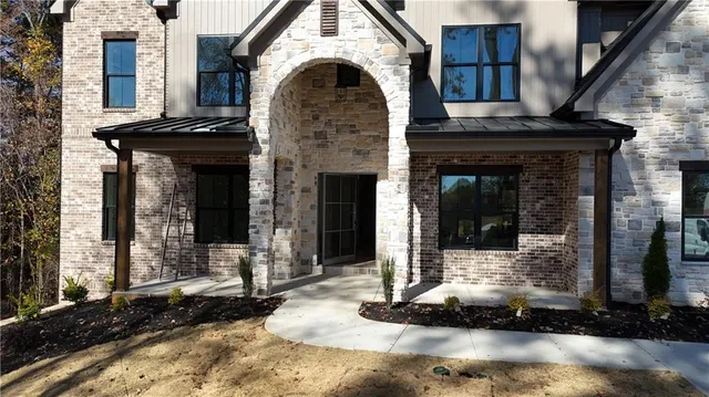 a view of a hallway with wooden floor and windows