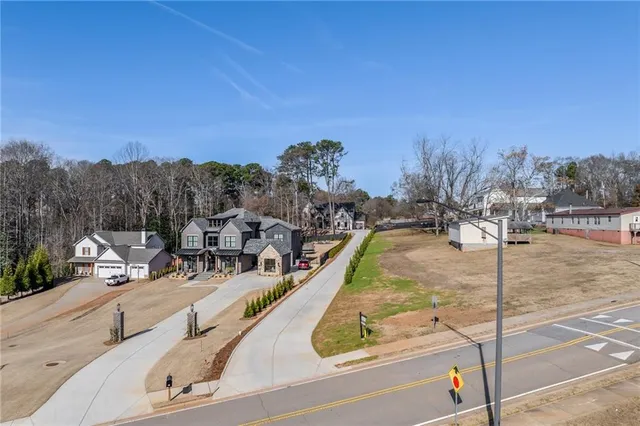 an empty room with windows and a ceiling fan