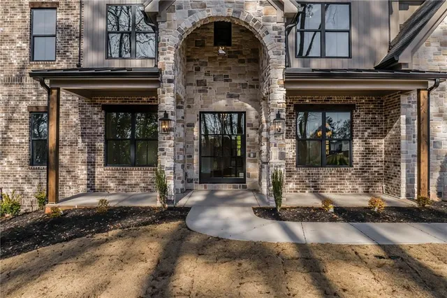 a view of empty room with wooden floor and fireplace