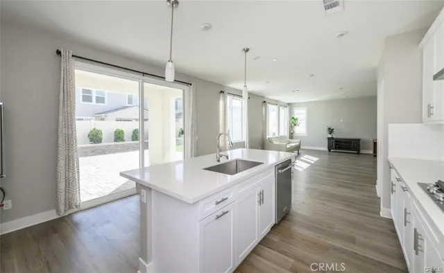 a kitchen with sink cabinets and wooden floor