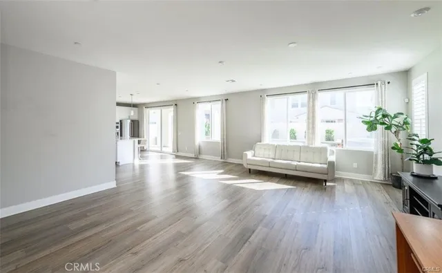 a view of a room with wooden floor and furniture