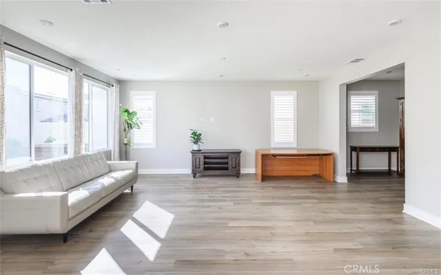 a living room with fireplace furniture and two window