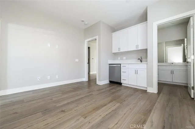 a view of a kitchen with wooden floor and a sink