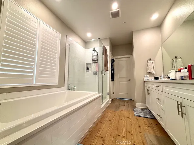 a spacious bathroom with a large tub and shower