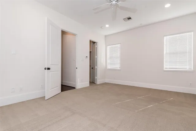 an empty room with windows and closet