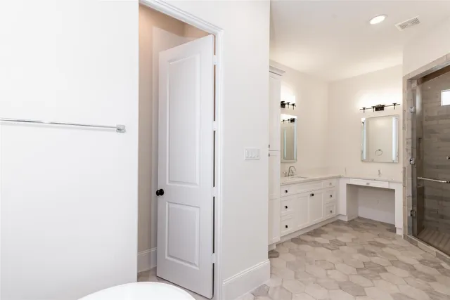 a bathroom with a granite countertop sink mirror and toilet