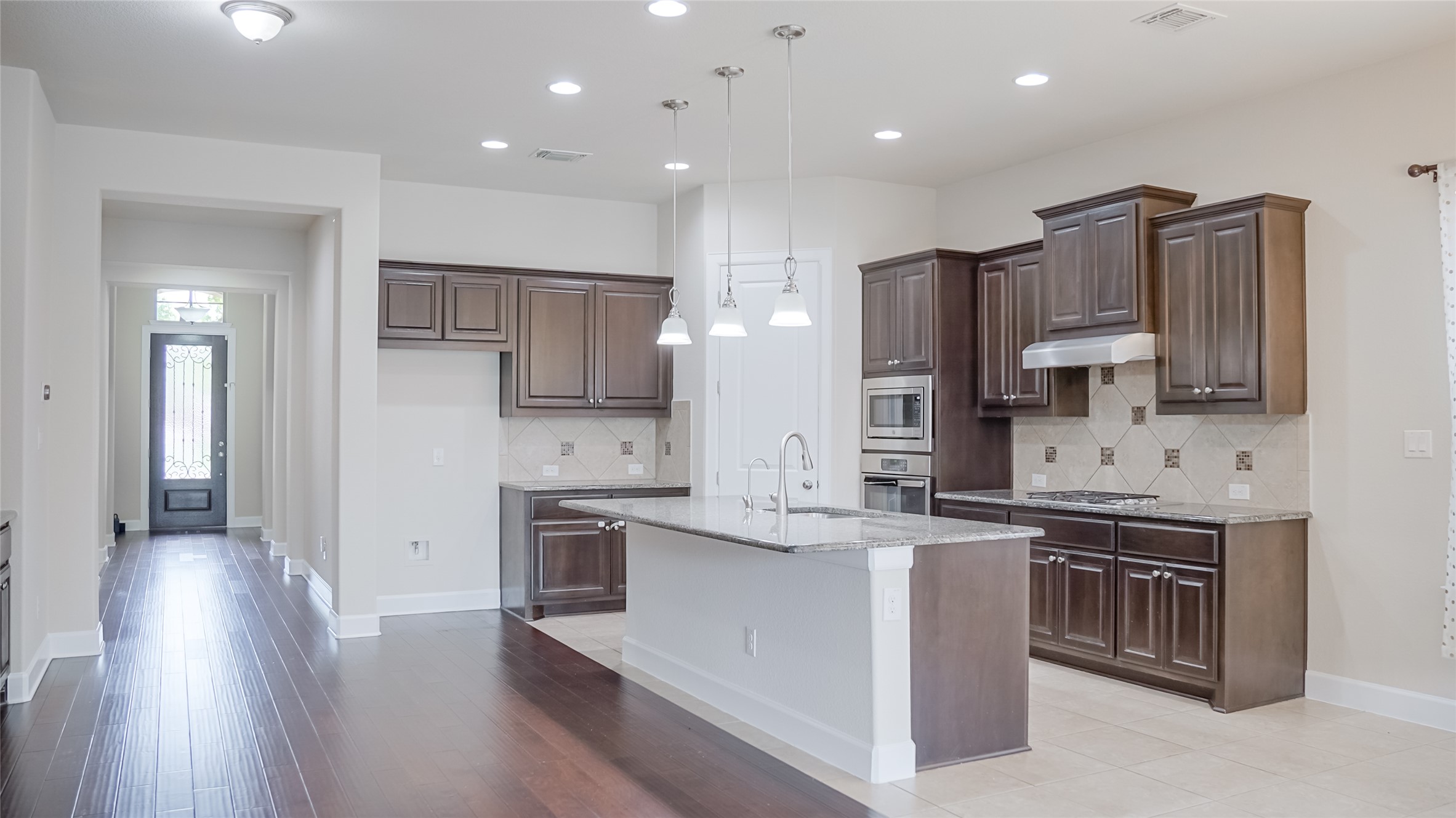 184 Fort Cobb Way Georgetown, TX 78628 - Photo 15 of 33 a kitchen with stainless steel appliances granite countertop a sink stove and refrigerator
