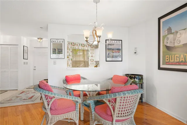 a living room with furniture a flat screen tv and kitchen view