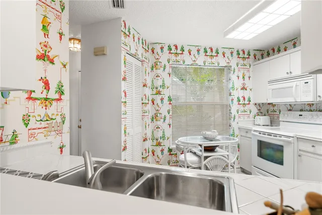 a kitchen with a refrigerator a stove a washer and dryer