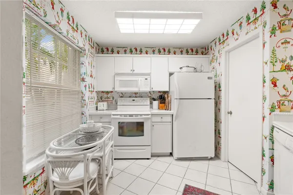 a kitchen with a refrigerator a stove a washer and dryer