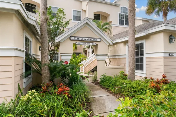 a aerial view of a house with a yard and potted plants