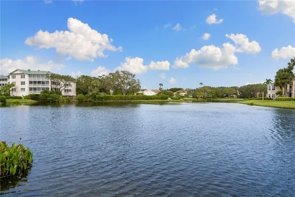 a view of a lake with houses in the background