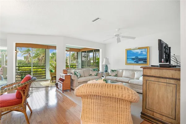 a living room with furniture large window and flat screen tv