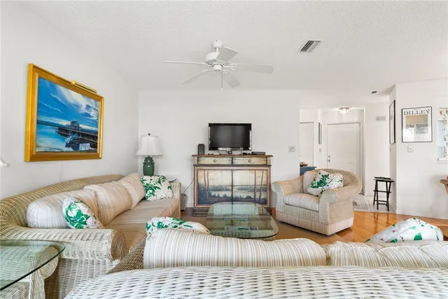 a dining room with furniture a large window and a chandelier
