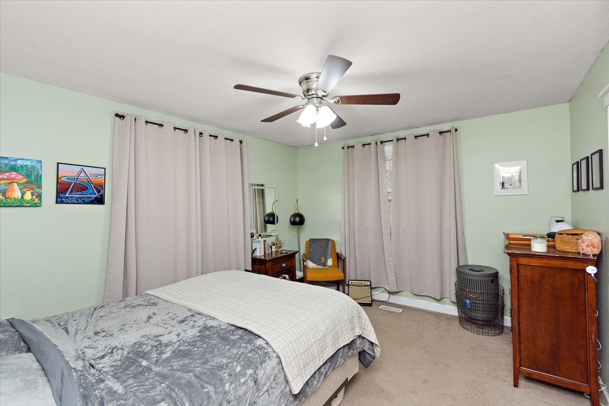 1081 Slaters Creek Road Goodlettsville, TN 37072 - Photo 12 of 22 a bedroom with a bed and a chandelier