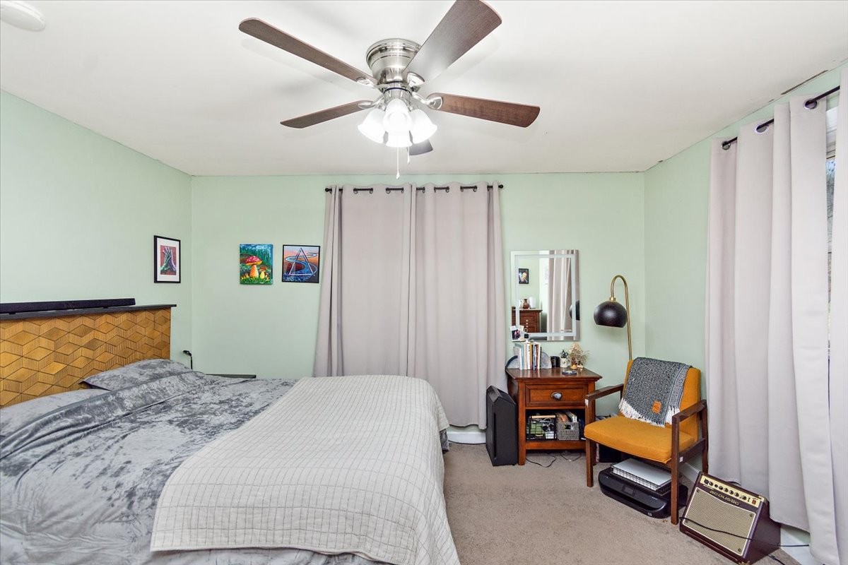 1081 Slaters Creek Road Goodlettsville, TN 37072 - Photo 13 of 22 a bedroom with a bed and a chandelier