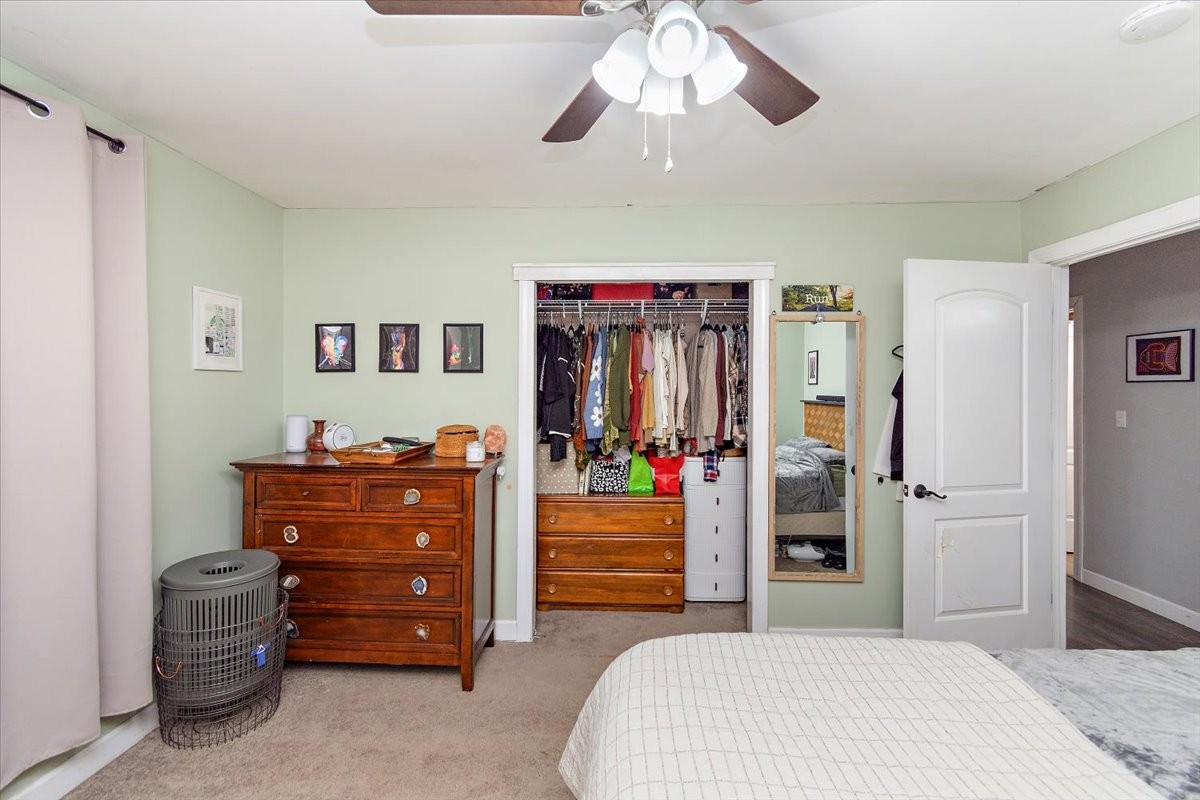1081 Slaters Creek Road Goodlettsville, TN 37072 - Photo 14 of 22 a bedroom with a bed and a chandelier