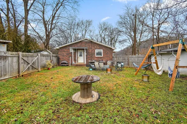 a view of a house with backyard porch and sitting area