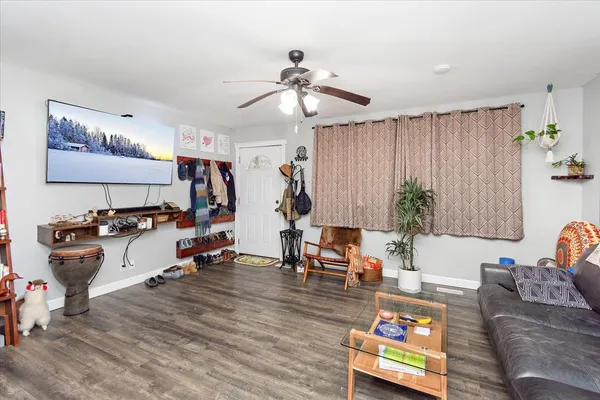 a living room with furniture and wooden floor
